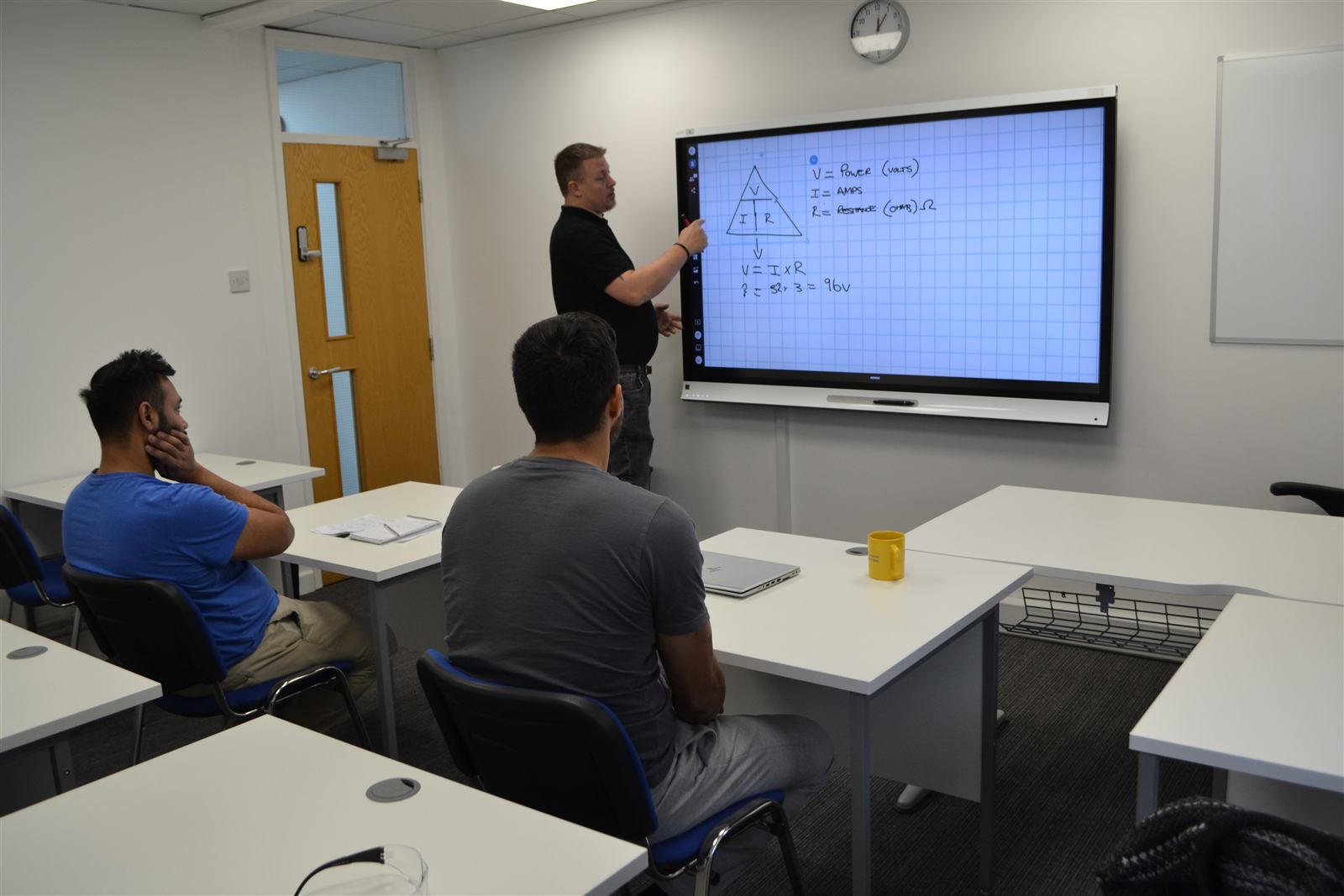 An instructor answering a question during an adult-learner workshop session